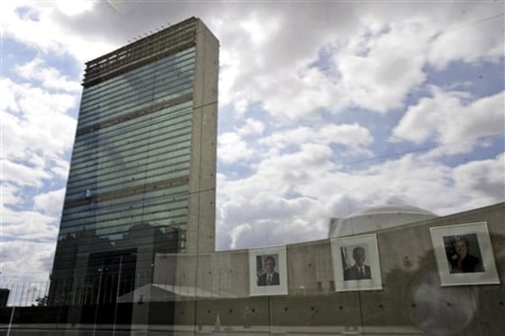 The United Nations building in New York City is reflected on the window of the U.S. mission to the U.N. as portraits of American President Barack Obama, left, Vice President Joe Biden, and Secretary of State Hillary Clinton hang in the lobby.